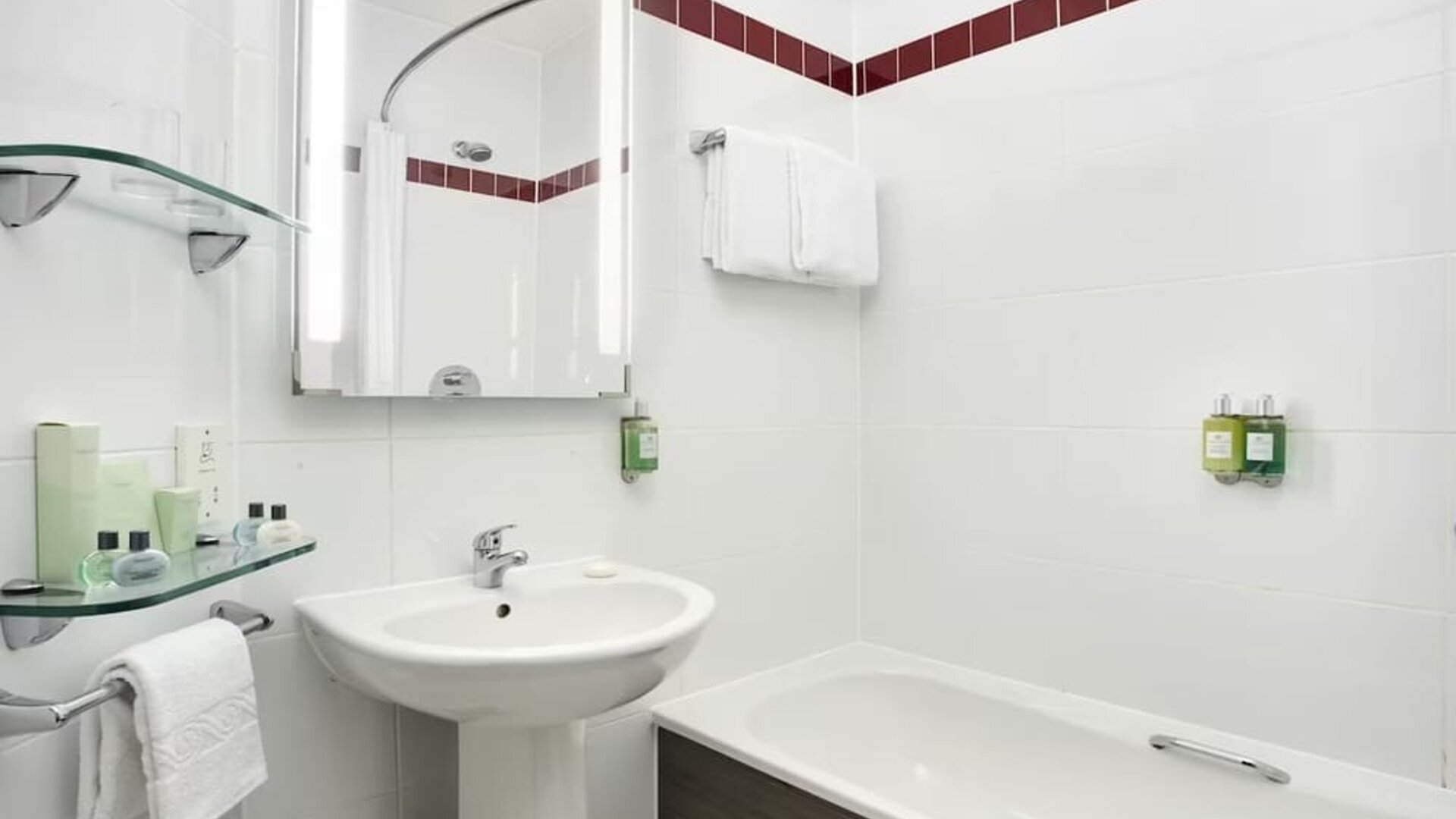 Guest bathroom with shower and tub at Leonardo Hotel Liverpool.