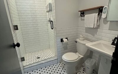 Guest bathroom with shower at Tribeca Hotel FiDi.