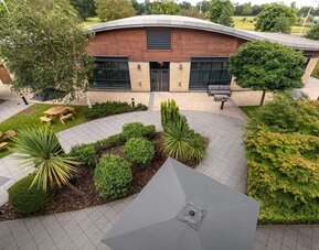 Seats and table available in the garden at Hilton Garden Inn London Heathrow Airport.