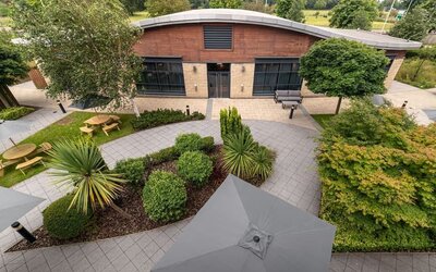 Seats and table available in the garden at Hilton Garden Inn London Heathrow Airport.