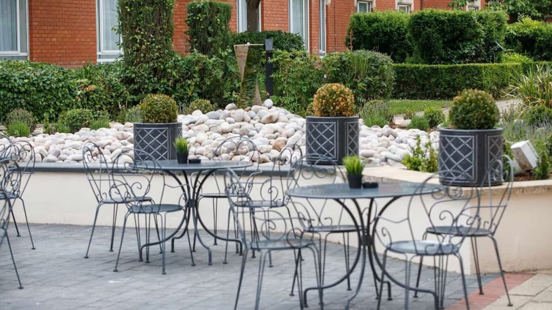 Seats and tables available in the garden at Hilton Northampton.