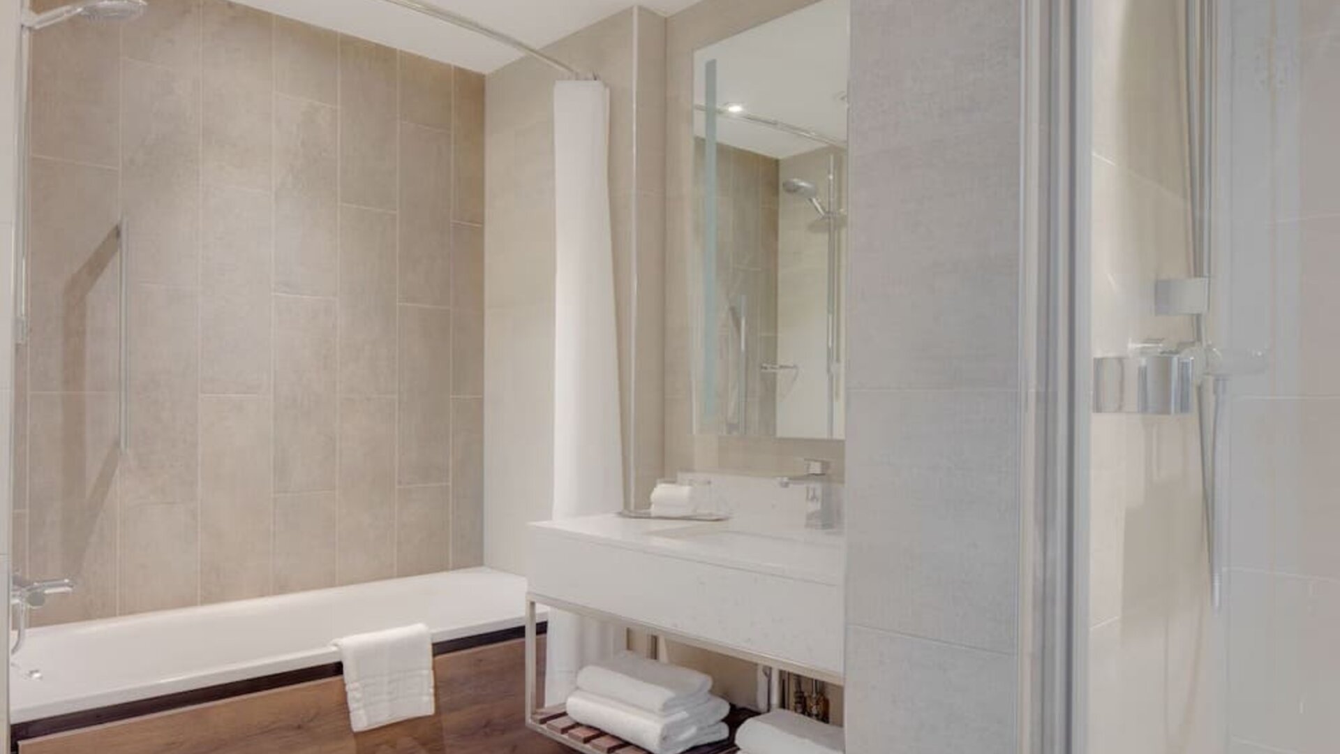 Guest bathroom with shower and tub at Hilton Edinburgh Carlton.