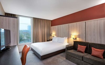 Day use room with sofa and large window at DoubleTree By Hilton London Excel.