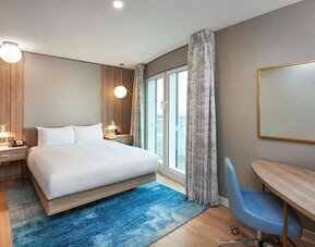 Day use room with work desk and balcony at DoubleTree By Hilton London Excel.