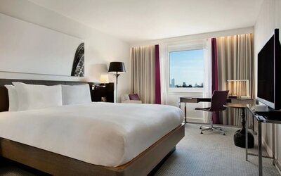 Delux king bed with work desk at Hilton London Angel Islington.
