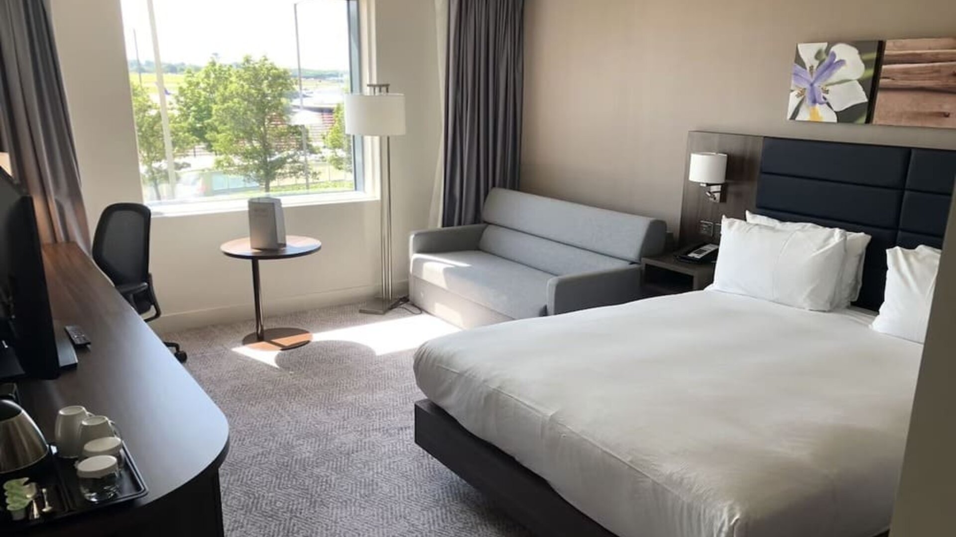 Day use room with work desk and sofa at Hilton Garden Inn Birmingham Airport.