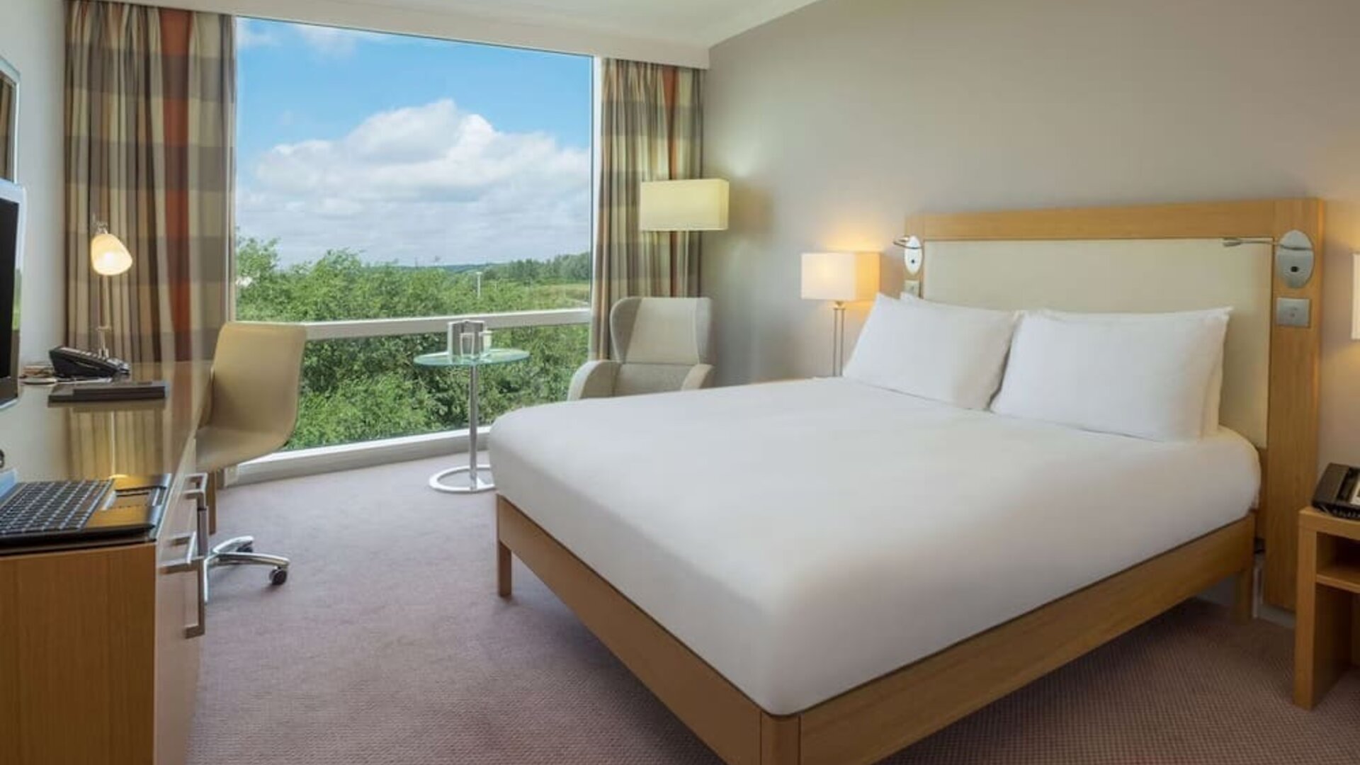 Bright king bedroom with view at the Hilton Reading.