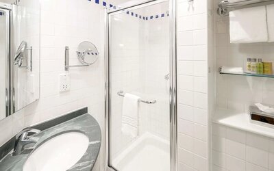 Guest bathroom with shower at Hilton Garden Inn Bristol City Centre.