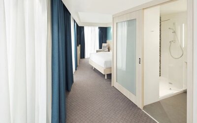 Bright day use room with TV, sofa and private bathroom at the Hampton by Hilton London Docklands.