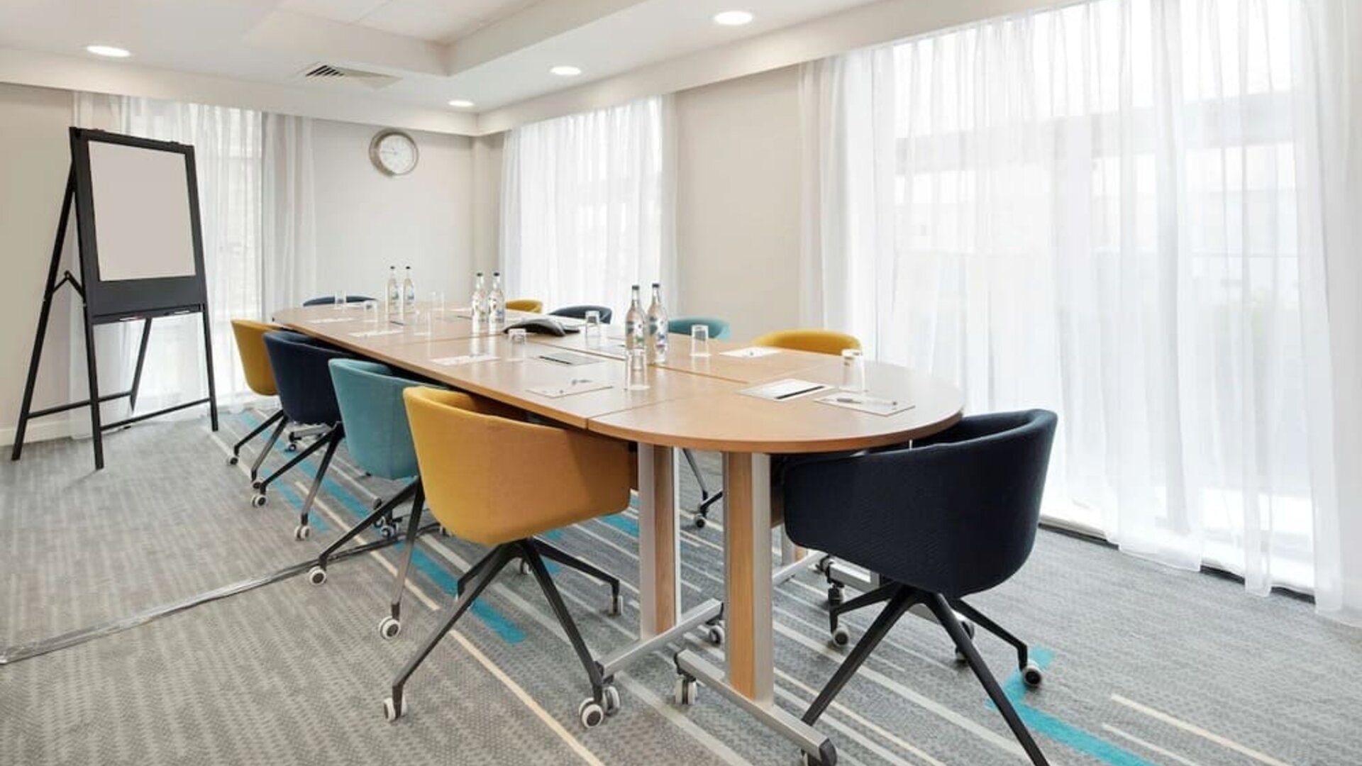 Bright meeting room with blackboard and comfortable mobiliary at the Hampton by Hilton London Docklands.