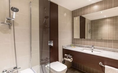 Guest bathroom with shower and free toiletries at the Hilton London Gatwick Airport.