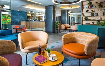 Lobby and coworking lounge at Hampton By Hilton London Park Royal.