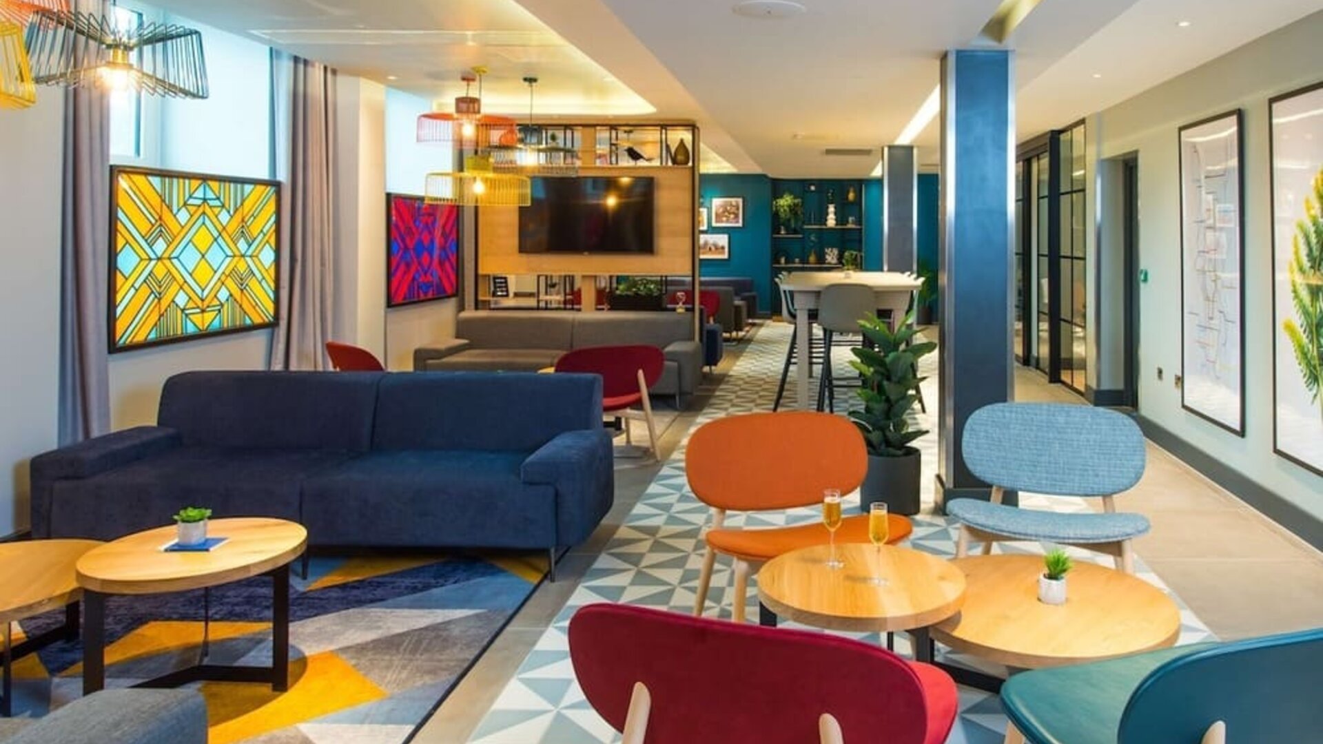 Lobby and coworking lounge at Hampton By Hilton London Park Royal.