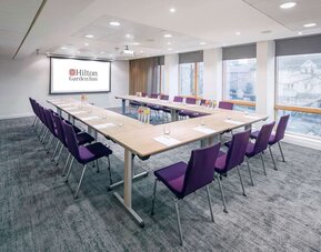 Spacious meeting room with comfortable mobiliary and large windows at the Hilton Garden Inn Birmingham Brindleyplace.