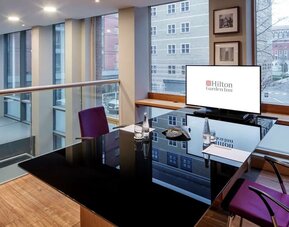 Meeting room with TV and large windows at the Hilton Garden Inn Birmingham Brindleyplace.