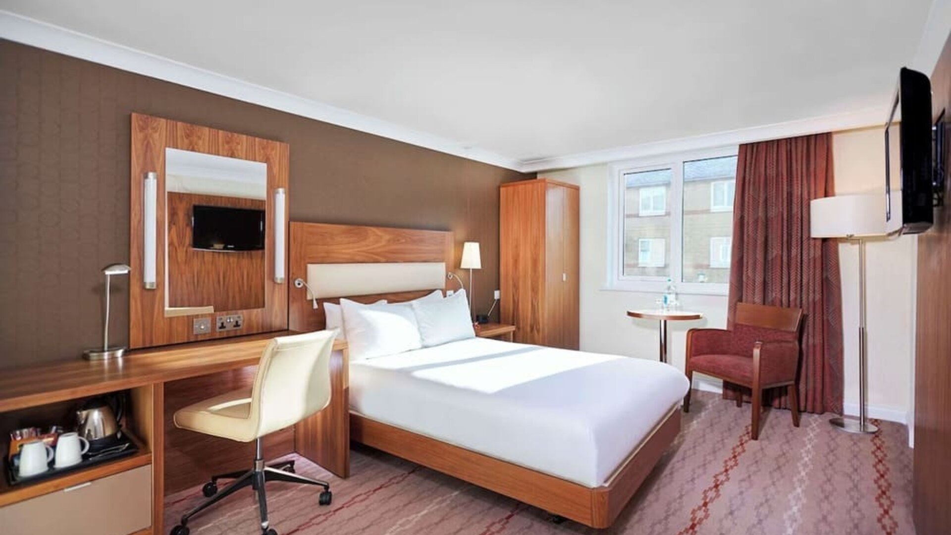 Day use room with TV, work desk and lounge area at the DoubleTree by Hilton Bristol North.