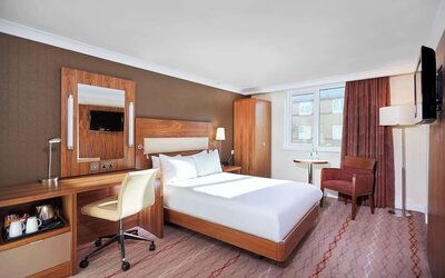 Day use room with TV, work desk and lounge area at the DoubleTree by Hilton Bristol North.