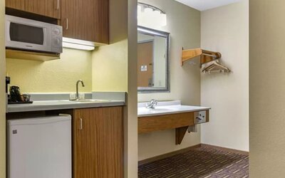 Guest bathroom and kitchen area at Coratel Inn & Suites By Jasper River Falls.
