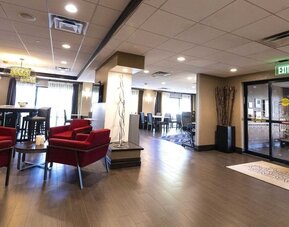 Inviting lobby lounge featuring comfortable seating, contemporary décor, and welcoming spaces to relax or socialize at Hampton Inn Ridgefield Park.