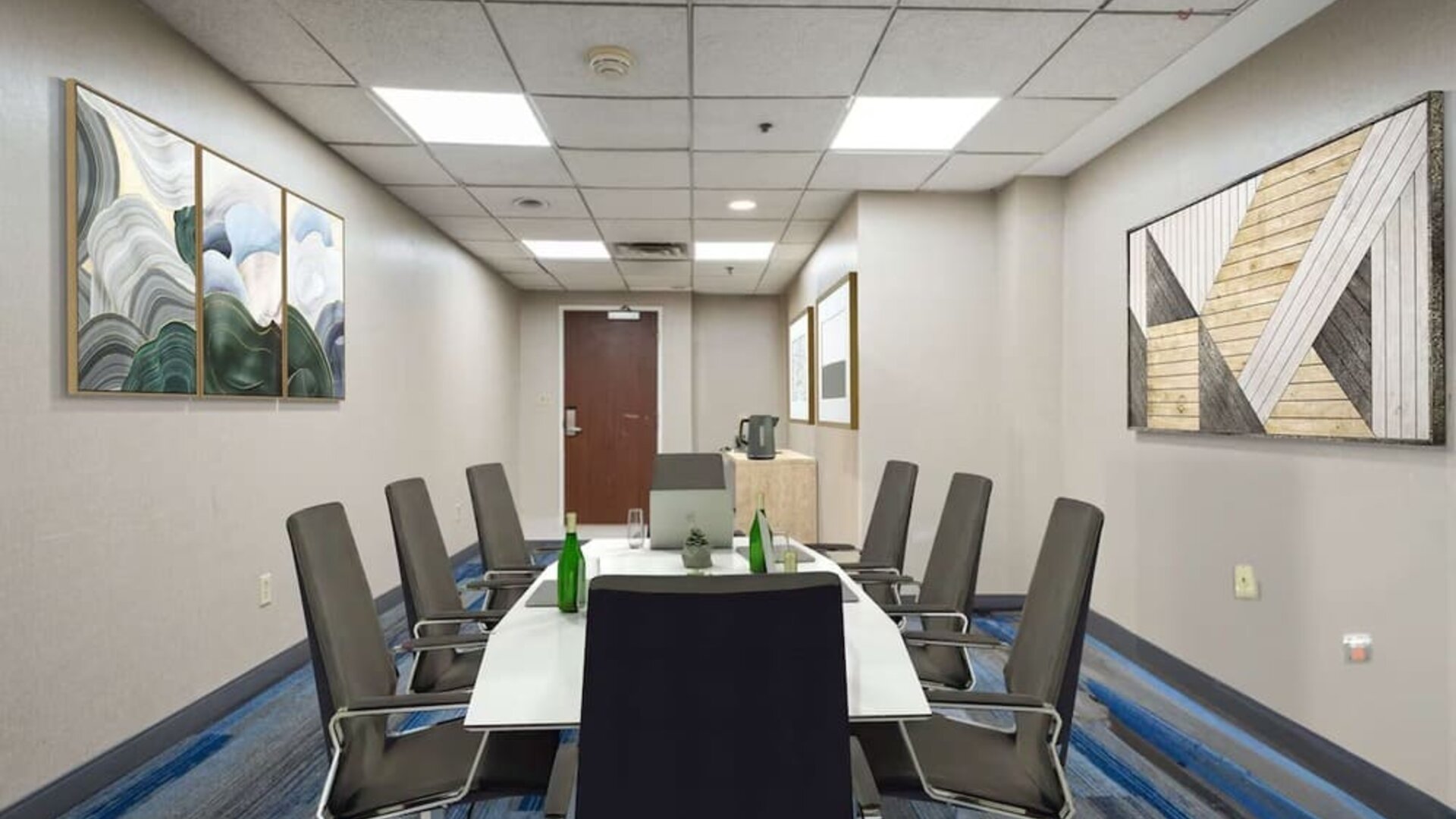 Meeting room featuring a professional boardroom setup, comfortable seating, and modern facilities for business meetings and small group events.
