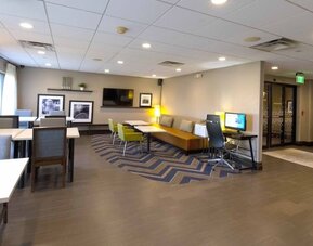 Comfortable lounge area featuring casual seating, business amenities, and inviting spaces to relax or enjoy a meal at Hampton Inn Ridgefield Park.