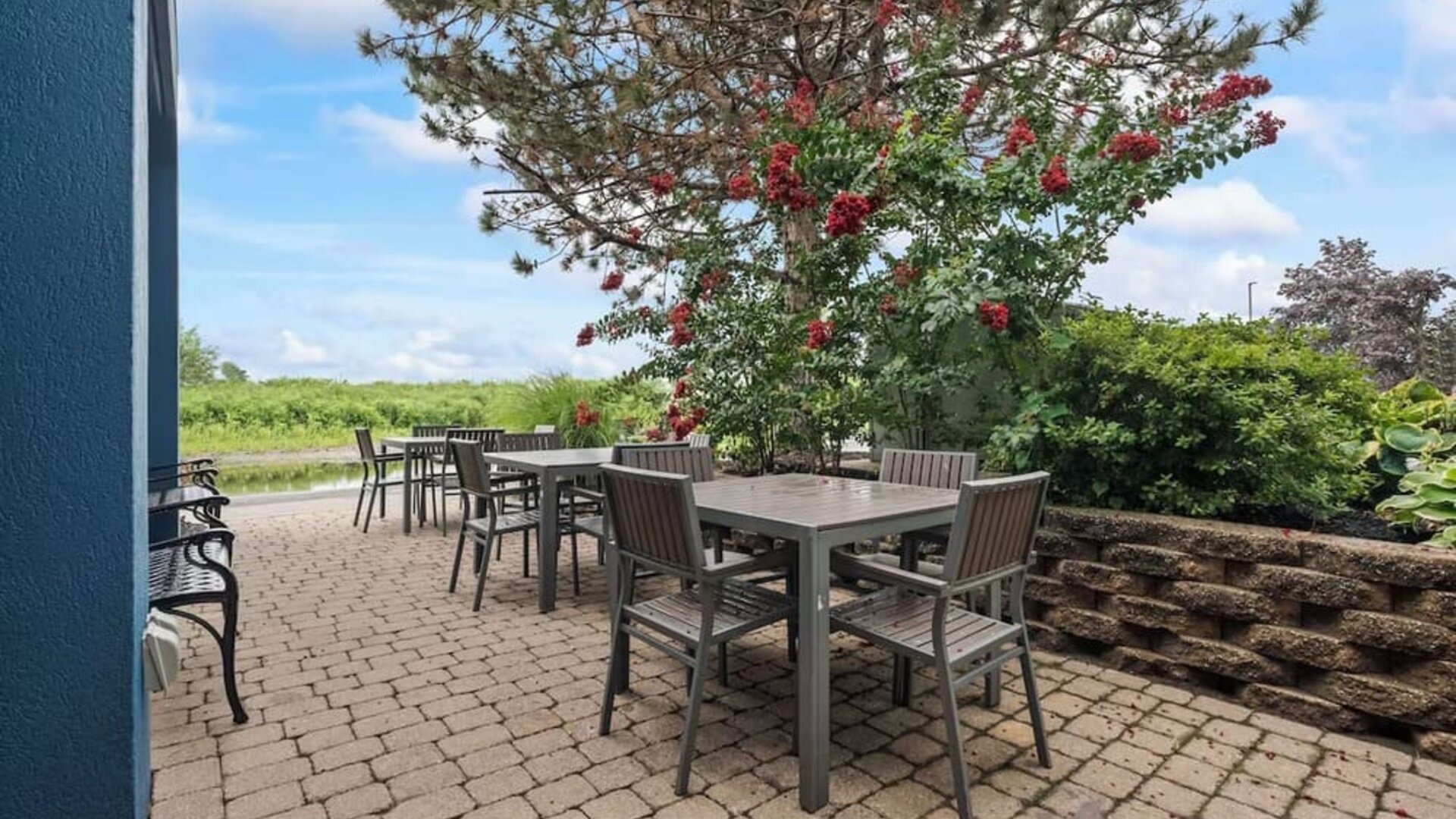 Outdoor terrace offering patio seating, lush landscaping, and a tranquil setting for enjoying fresh air during your stay at Hampton Inn Ridgefield Park.