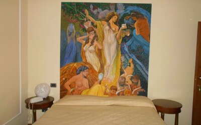 Comfortable guest room featuring a double bed, classic furnishings, and a striking decorative artwork.