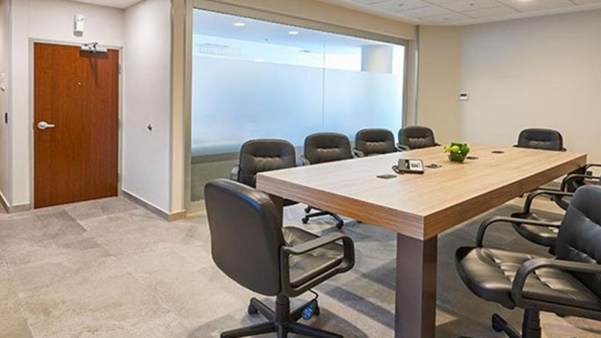 Private meeting room with conference table seating, suitable for business meetings, presentations, and small corporate events.