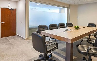 Private meeting room with conference table seating, suitable for business meetings, presentations, and small corporate events.