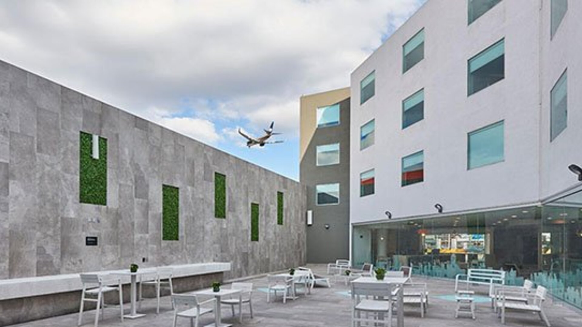Outdoor courtyard patio with seating areas and open-air space, providing a relaxing environment near the hotel.