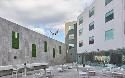 Outdoor courtyard patio with seating areas and open-air space, providing a relaxing environment near the hotel.