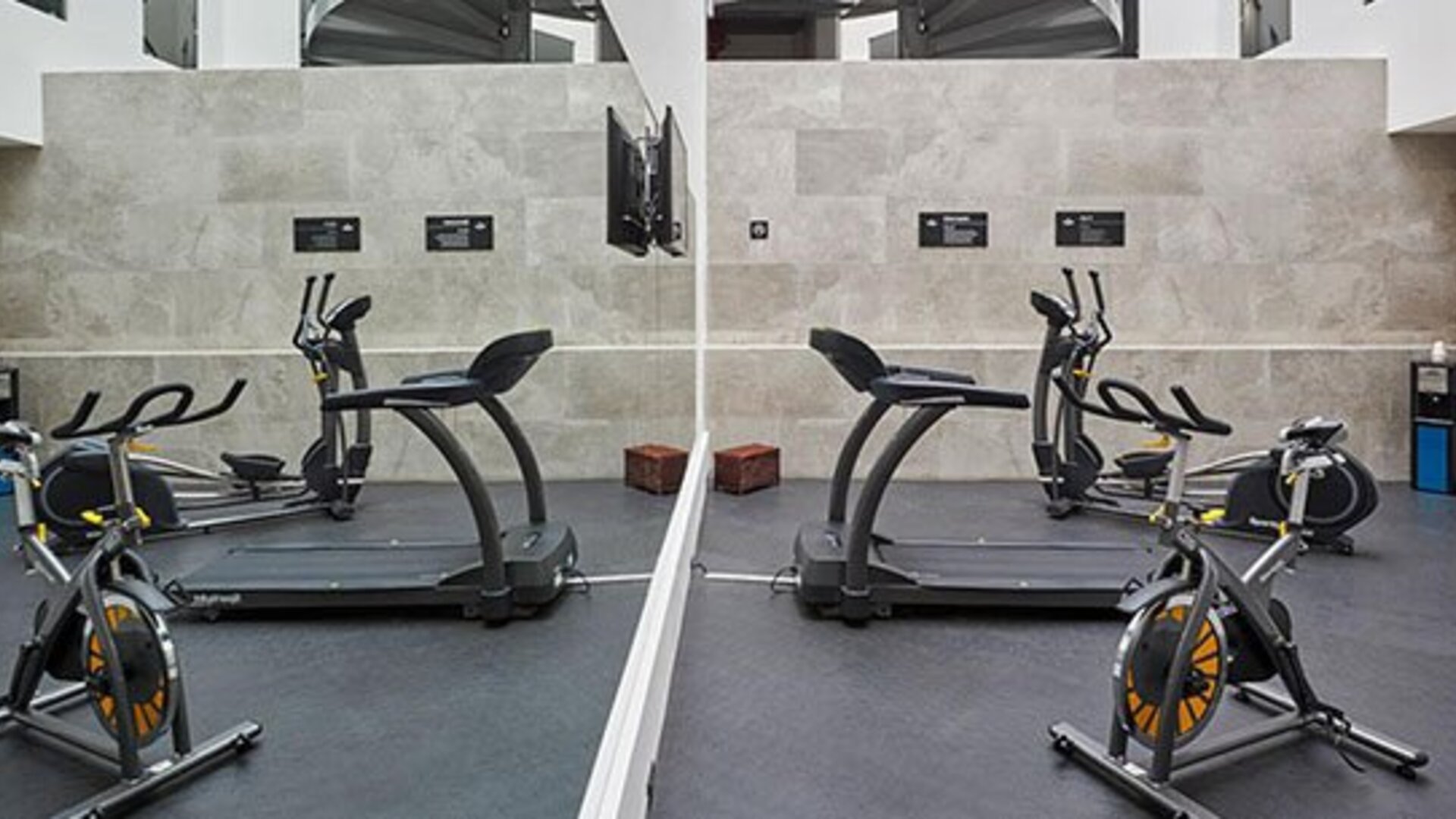 Fitness center equipped with cardio machines, exercise bikes, and workout space for guests maintaining their fitness routines.