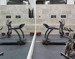 Fitness center equipped with cardio machines, exercise bikes, and workout space for guests maintaining their fitness routines.