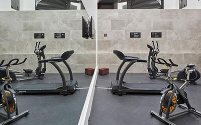 Fitness center equipped with cardio machines, exercise bikes, and workout space for guests maintaining their fitness routines.