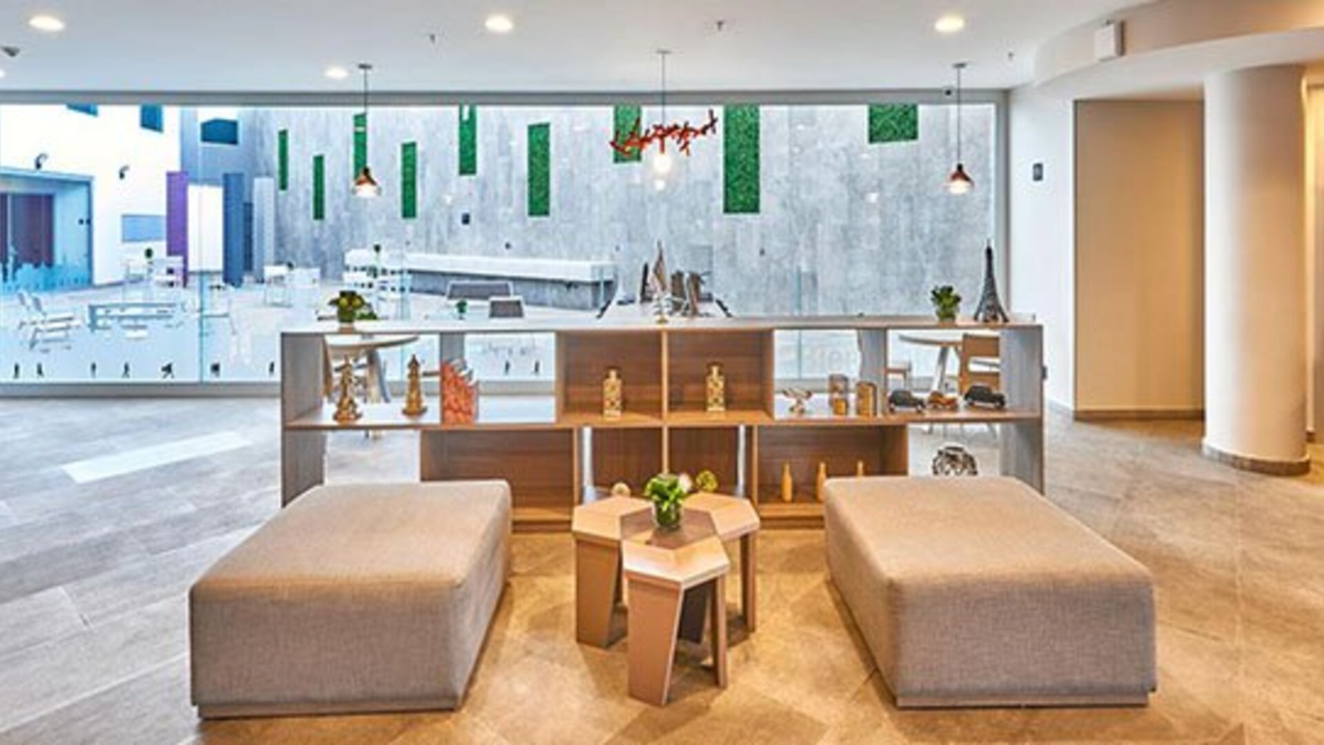 Spacious communal seating area overlooking the hotel's central atrium, offering a bright and inviting atmosphere.