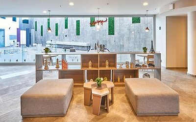 Spacious communal seating area overlooking the hotel's central atrium, offering a bright and inviting atmosphere.