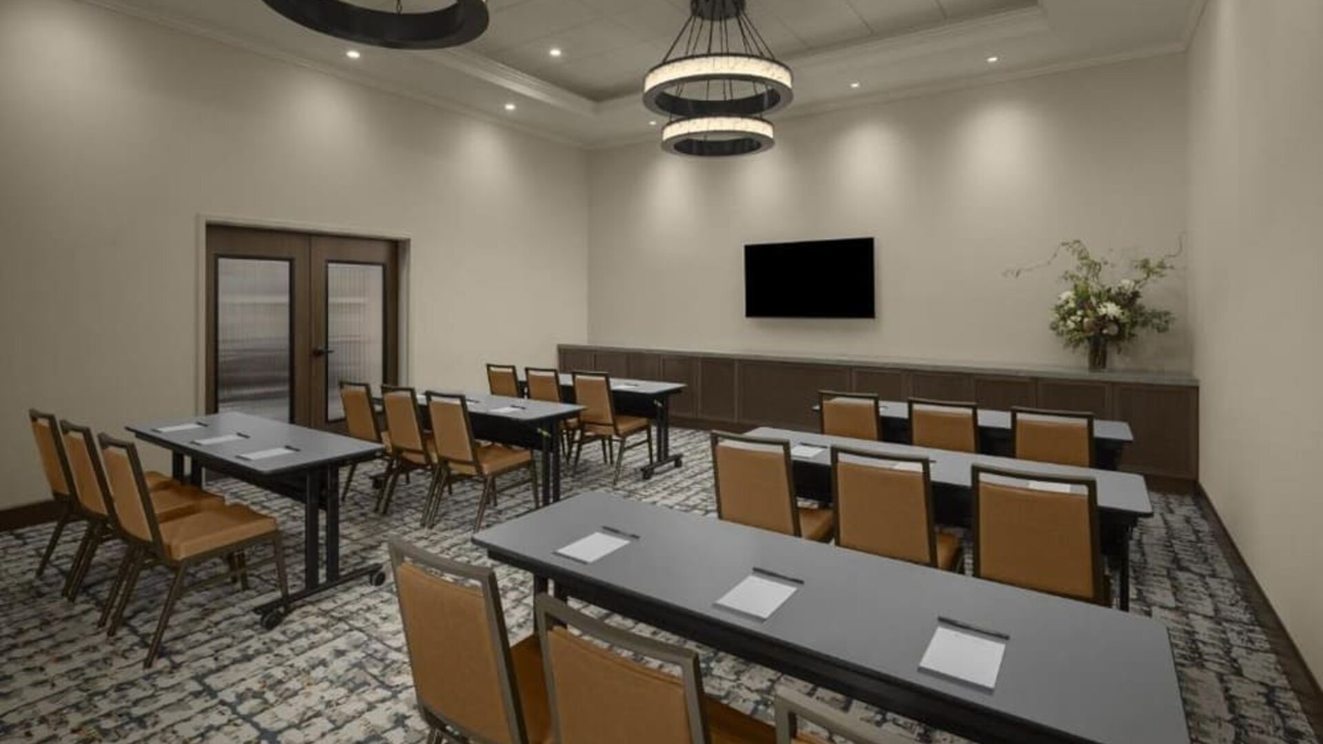 Meeting room with classroom-style seating, wall-mounted television, and flexible event space at Hyatt Place Bozeman Yellowstone Airport.