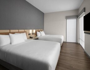 Guest room with two queen beds, contemporary décor, and wall-mounted television at Hyatt Place Bozeman Yellowstone Airport.