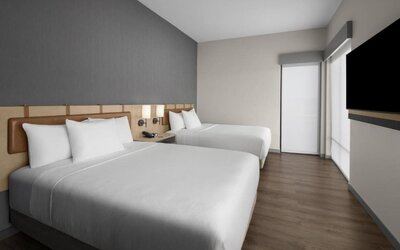 Guest room with two queen beds, contemporary décor, and wall-mounted television at Hyatt Place Bozeman Yellowstone Airport.