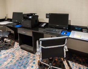 Business center with desktop computers, printer, and workstations at Hampton Inn & Suites Orlando at SeaWorld.