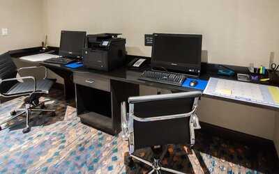 Business center with desktop computers, printer, and workstations at Hampton Inn & Suites Orlando at SeaWorld.