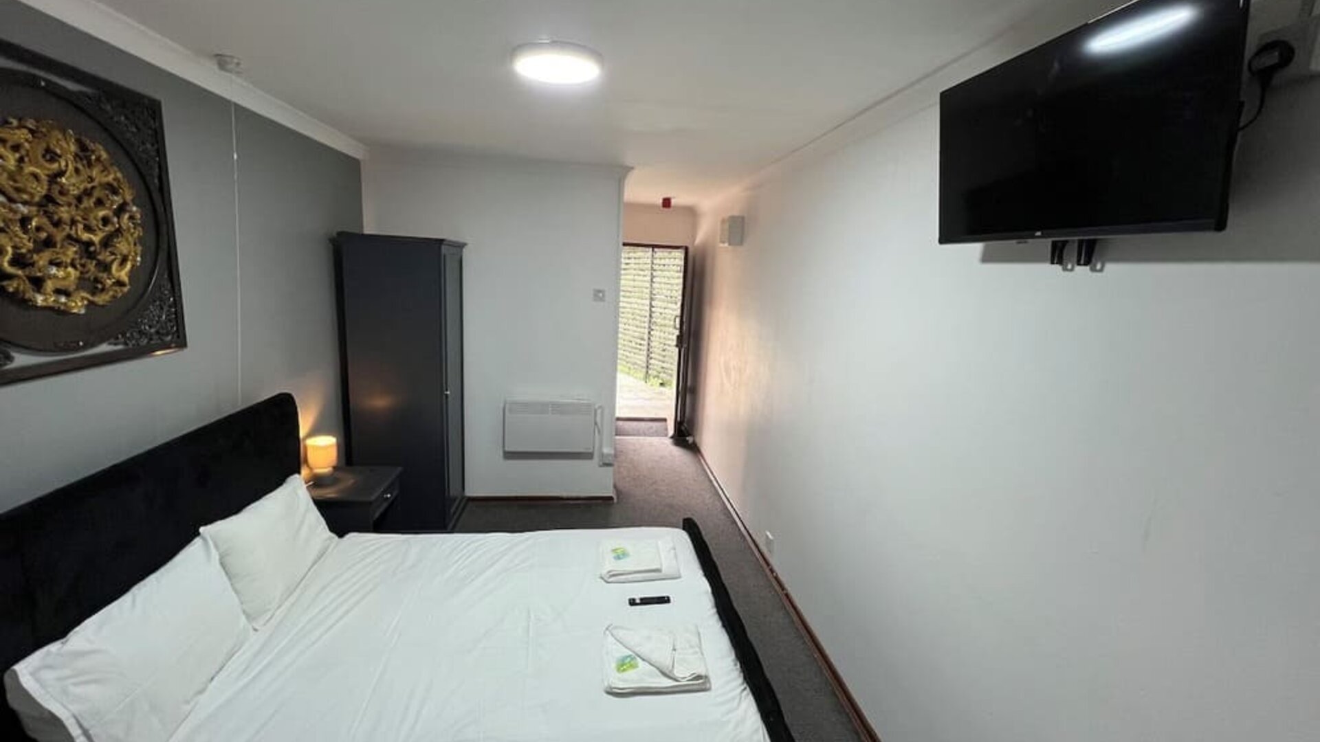 King guest room with comfortable bed, flat-screen television, and contemporary furnishings at Stay Inn Express.