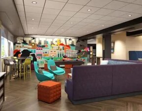 Vibrant hotel lobby with comfortable seating, games, and social gathering spaces at Tru By Hilton Lithia Springs.