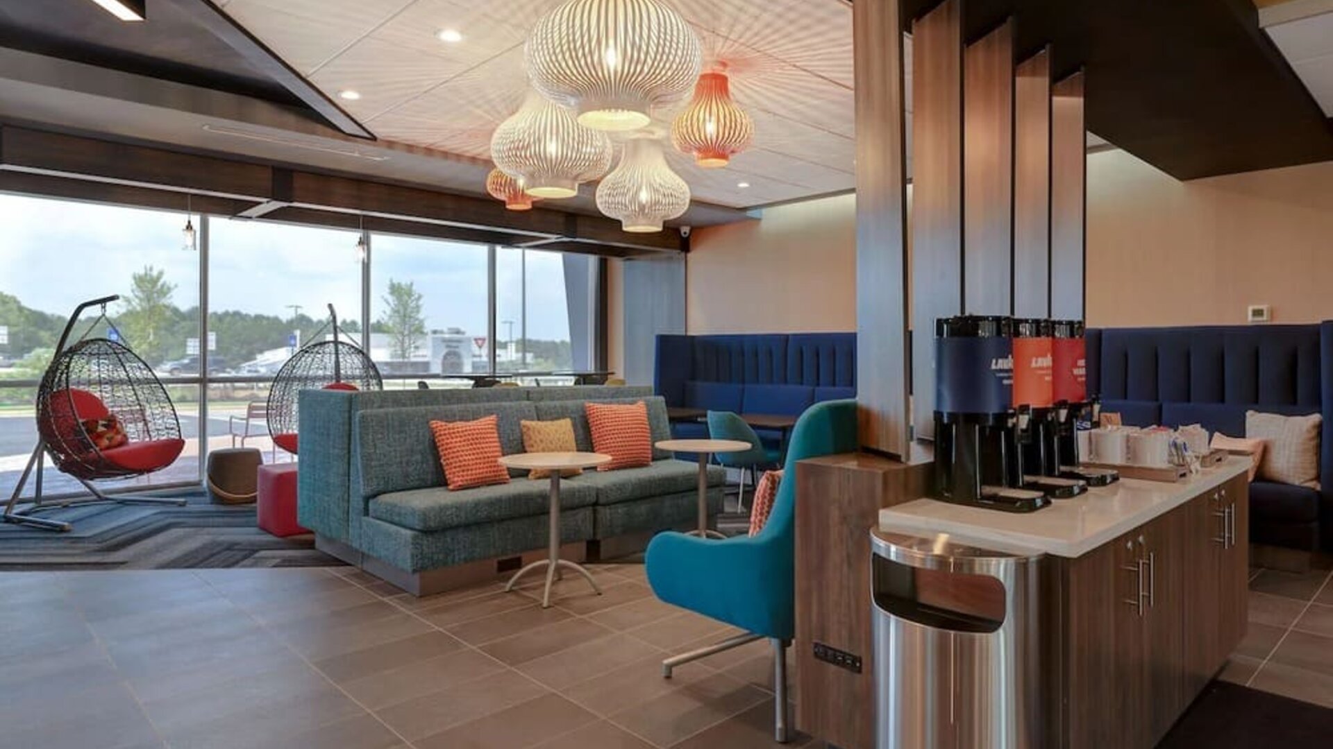 Lobby seating area with complimentary coffee station and contemporary furnishings at Tru By Hilton Lithia Springs.