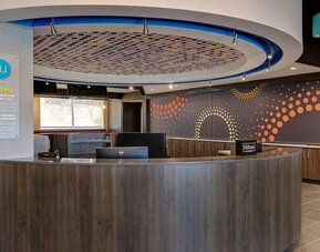 Modern reception area with front desk services and guest check-in at Tru By Hilton Lithia Springs.