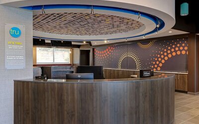 Modern reception area with front desk services and guest check-in at Tru By Hilton Lithia Springs.