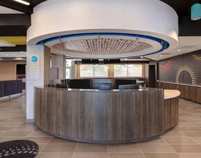 Contemporary reception desk with welcoming lobby and guest services at Tru By Hilton Lithia Springs.