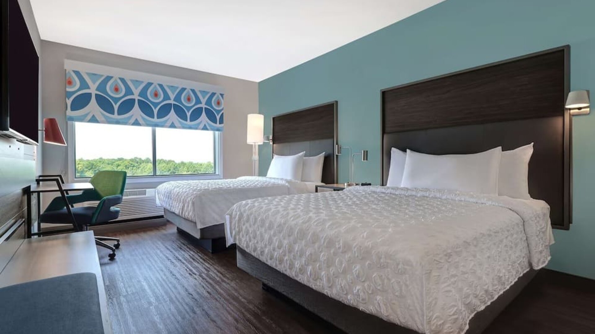 Guest room with two queen beds, workspace, and modern décor at Tru By Hilton Lithia Springs.