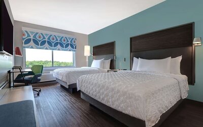 Guest room with two queen beds, workspace, and modern décor at Tru By Hilton Lithia Springs.