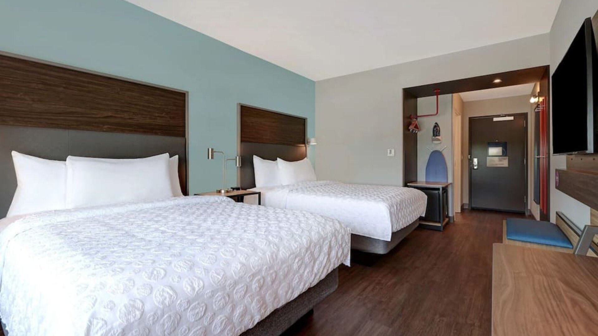 Guest room workspace with desk, flat-screen TV, and comfortable seating at Tru By Hilton Lithia Springs.